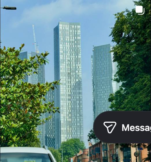 Glass city skyscrapers seen through street trees