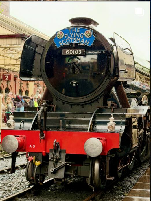The Flying Scotsman steam locomotive at a station platform